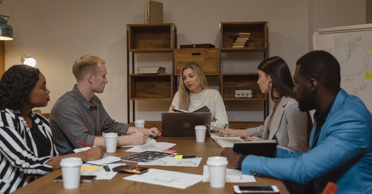 Business team discussing strategies in a modern office setting, focusing on collaboration.